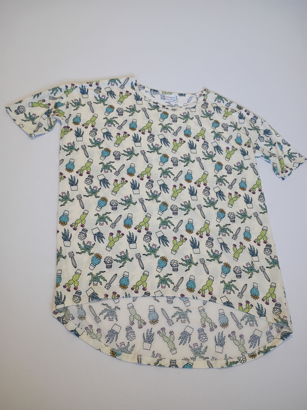 Lularoe Irma tunic top features a whimsical cactus print On Cream Size M